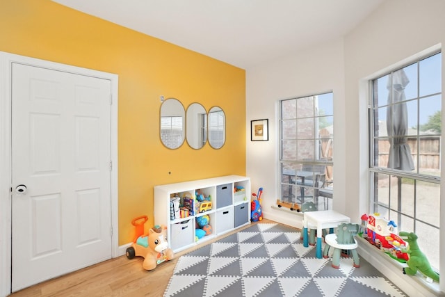 rec room featuring baseboards and wood finished floors