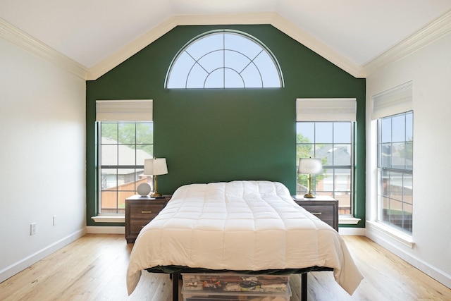 bedroom with multiple windows, wood finished floors, and lofted ceiling