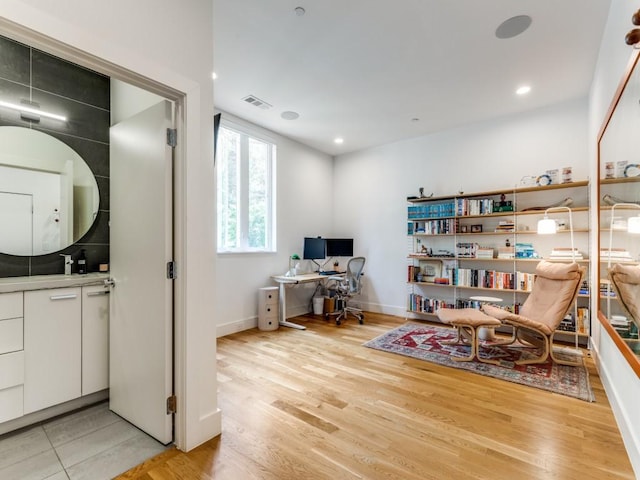 interior space with visible vents, recessed lighting, light wood-style flooring, and baseboards