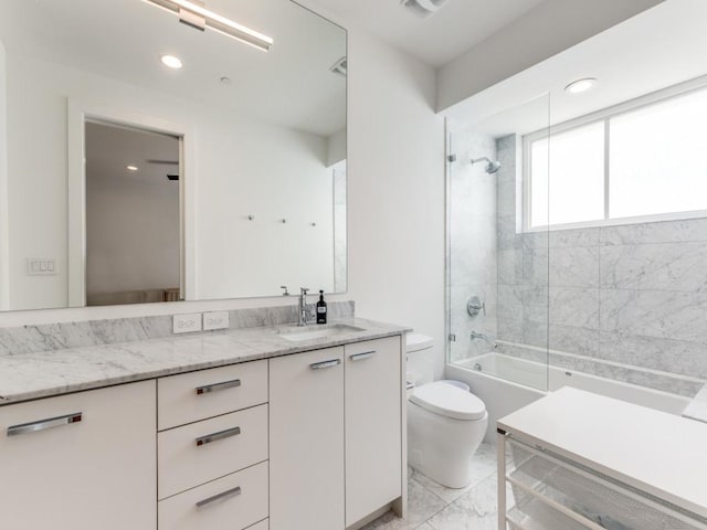 bathroom with vanity, toilet, marble finish floor, recessed lighting, and shower / washtub combination