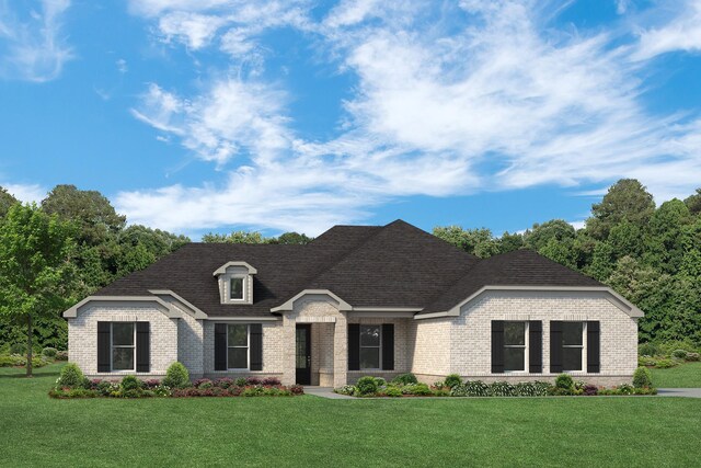 view of front facade with brick siding and a front yard
