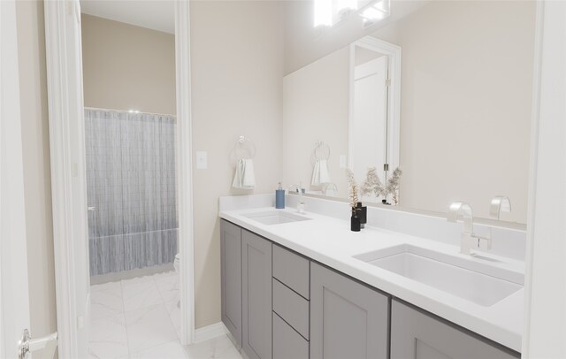 bathroom with double vanity, a sink, marble finish floor, and a shower with shower curtain