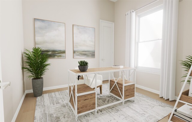 home office with baseboards and light wood finished floors
