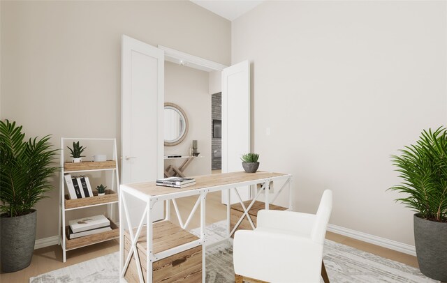 office with baseboards and light wood-style flooring