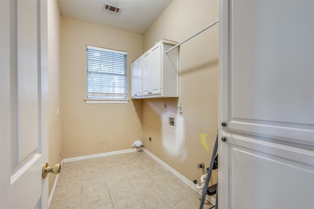 clothes washing area with washer hookup, visible vents, hookup for a gas dryer, cabinet space, and baseboards