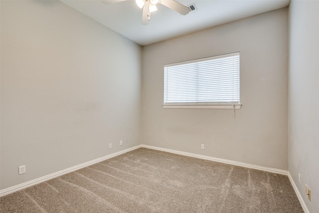 spare room featuring visible vents, carpet, ceiling fan, and baseboards