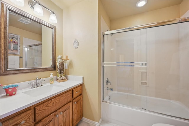 full bath featuring visible vents, bath / shower combo with glass door, and vanity