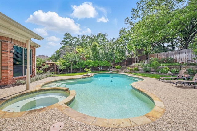 view of pool featuring a fenced backyard, a patio, and a pool with connected hot tub