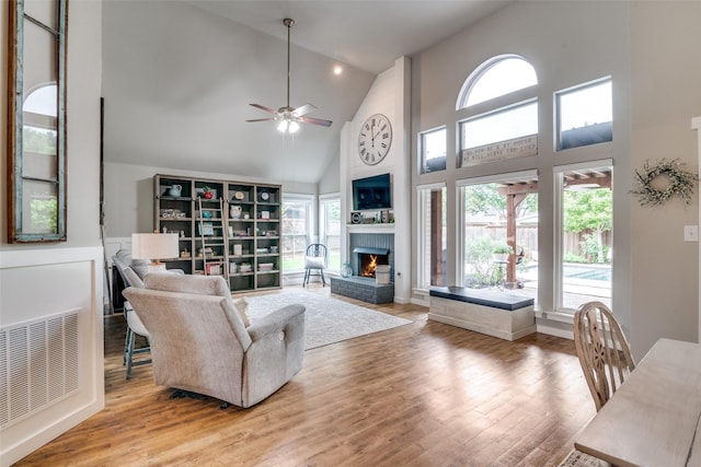 living room with high vaulted ceiling, visible vents, and plenty of natural light