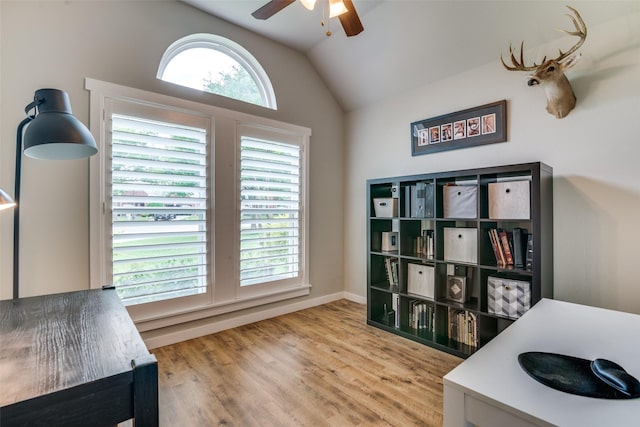 office featuring baseboards, a ceiling fan, wood finished floors, and lofted ceiling