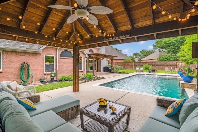 view of swimming pool featuring a gazebo, an outdoor living space, and a fenced backyard