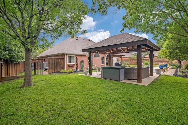 back of house with a lawn, a fenced backyard, a patio area, and a gazebo