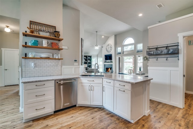 kitchen with a ceiling fan, visible vents, stainless steel dishwasher, a sink, and white cabinetry