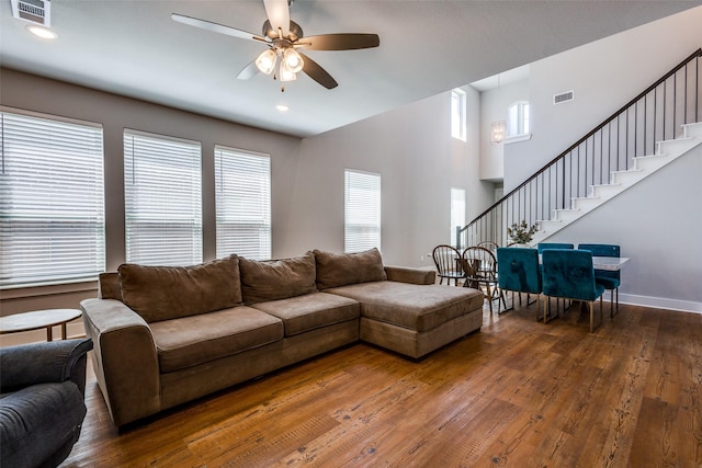 living room featuring stairway, a ceiling fan, hardwood / wood-style floors, and visible vents