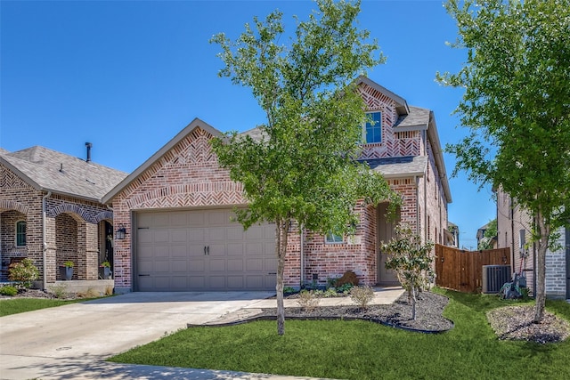 view of front facade with fence, a front yard, brick siding, concrete driveway, and an attached garage