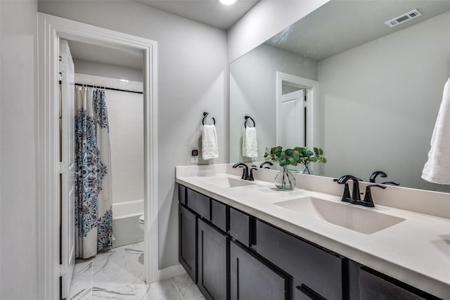 bathroom with double vanity, visible vents, a sink, and marble finish floor