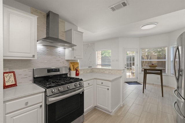 2624 Misty Glen Dr, Flower Mound, TX 75028 - kitchen with wall chimney range hood, stainless steel appliances, tasteful backsplash, and a peninsula