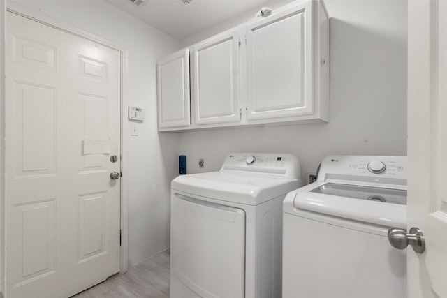 2624 Misty Glen Dr, Flower Mound, TX 75028 - laundry area with cabinet space, separate washer and dryer, and light wood-type flooring