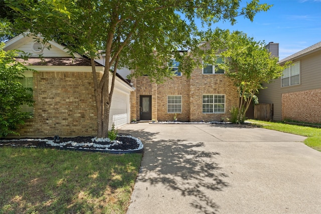 2624 Misty Glen Dr, Flower Mound, TX 75028 - view of front of house with an attached garage, brick siding, and concrete driveway
