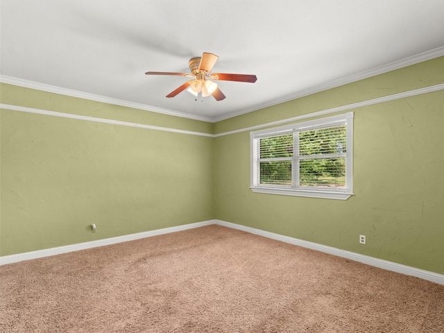 carpeted empty room featuring crown molding, baseboards, and a ceiling fan