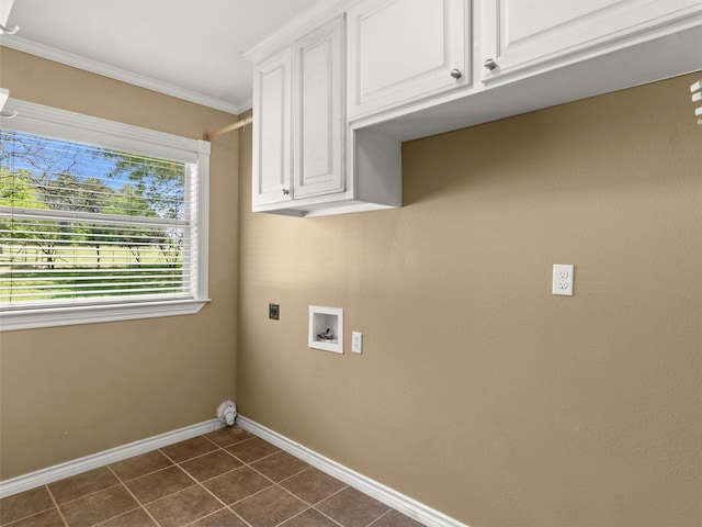 laundry area with crown molding, baseboards, dark tile patterned floors, cabinet space, and hookup for an electric dryer
