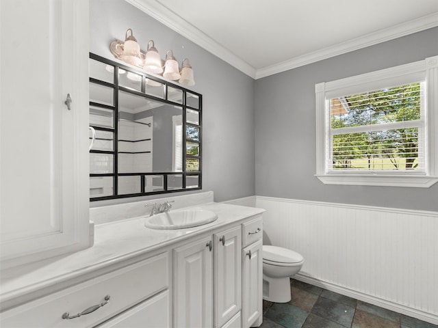 bathroom with vanity, ornamental molding, wainscoting, toilet, and walk in shower