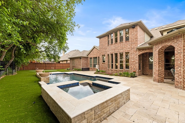 view of pool featuring a lawn, an in ground hot tub, a patio area, and a fenced backyard