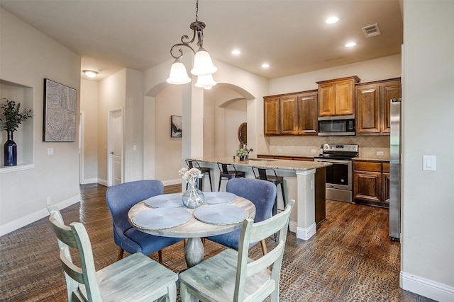 11948 Carlin Dr, Fort Worth, TX 76108 - dining space with visible vents, arched walkways, baseboards, and recessed lighting