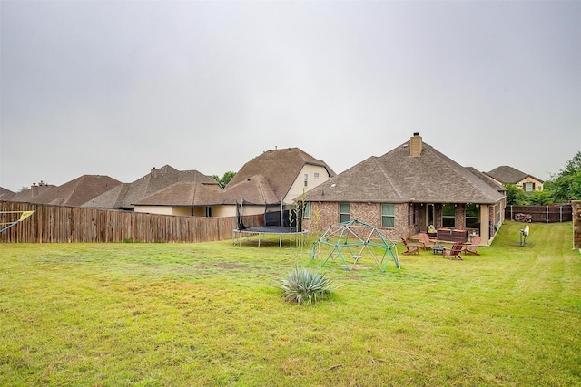 11948 Carlin Dr, Fort Worth, TX 76108 - exterior space with a fenced backyard, a trampoline, and a fire pit
