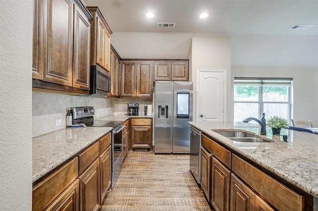 11948 Carlin Dr, Fort Worth, TX 76108 - kitchen with appliances with stainless steel finishes, a sink, visible vents, and light stone counters