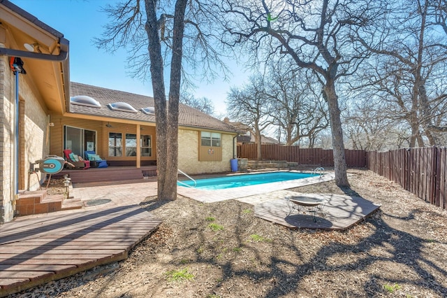 view of swimming pool with a patio, a fenced in pool, and a fenced backyard