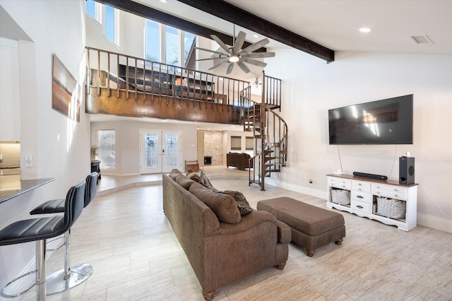 living area with high vaulted ceiling, stairs, baseboards, wood finished floors, and beamed ceiling