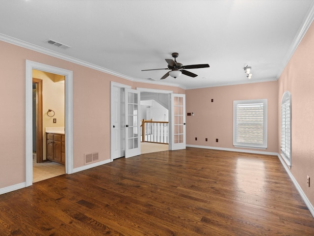 6916 April Way Cir, Plano, TX 75023 - spare room with a ceiling fan, french doors, visible vents, crown molding, and wood finished floors