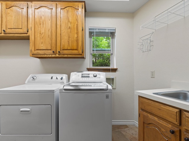 6916 April Way Cir, Plano, TX 75023 - washroom featuring washer and clothes dryer, a sink, cabinet space, and baseboards