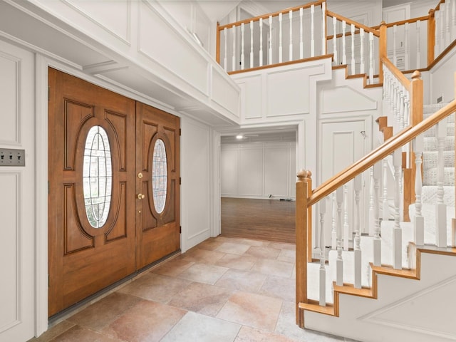 6916 April Way Cir, Plano, TX 75023 - entrance foyer featuring stairs, a decorative wall, and stone finish floor