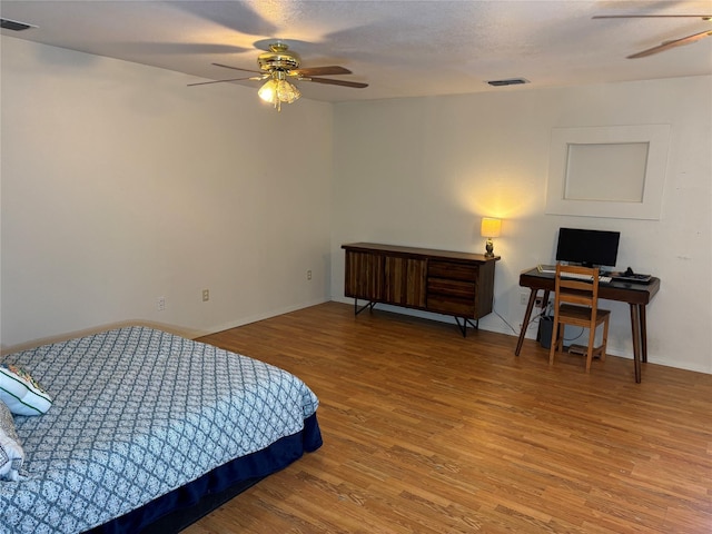1207 W Cage St, Stephenville, TX 76401 - bedroom with a ceiling fan, baseboards, visible vents, and wood finished floors