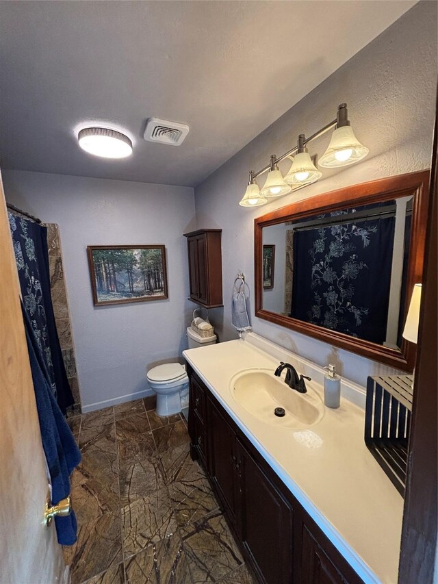 1207 W Cage St, Stephenville, TX 76401 - bathroom with visible vents, baseboards, toilet, and vanity