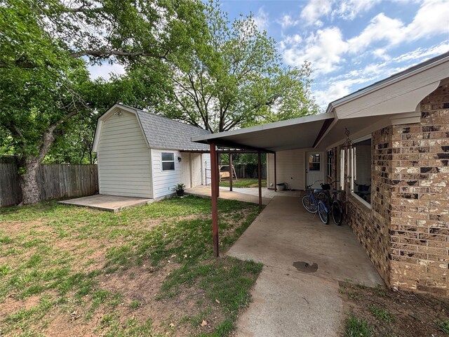 1207 W Cage St, Stephenville, TX 76401 - view of yard with fence, a storage unit, an outdoor structure, and a patio