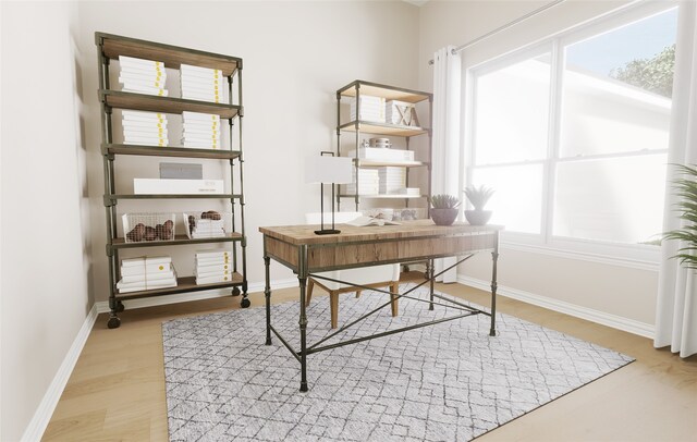 office area featuring baseboards and light wood-style flooring