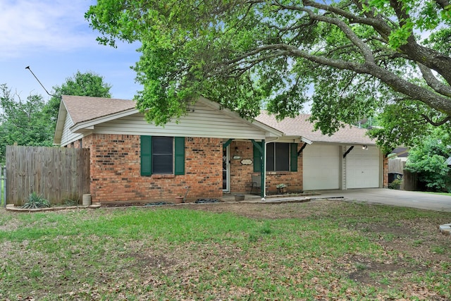 ranch-style house with brick siding, fence, driveway, and a garage