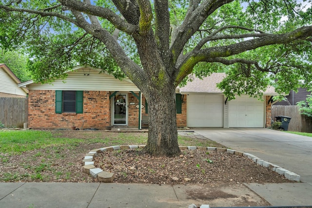 ranch-style home with fence, an attached garage, concrete driveway, and brick siding