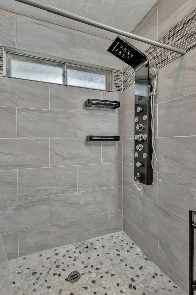 bathroom with tiled shower