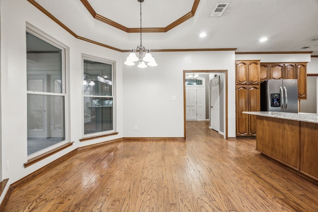 kitchen featuring stainless steel refrigerator with ice dispenser, visible vents, crown molding, light wood-type flooring, and an inviting chandelier