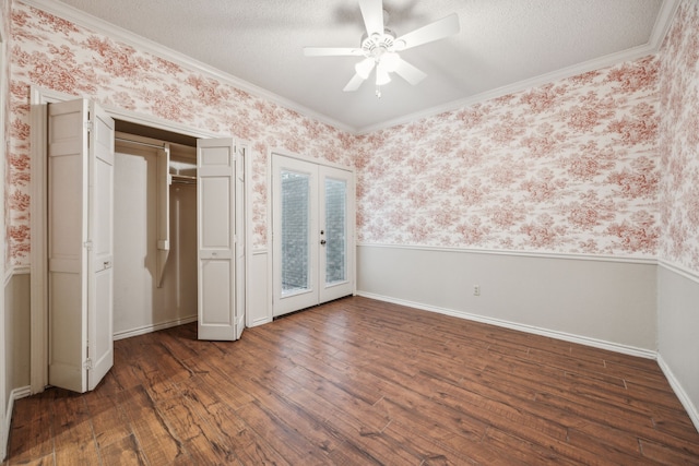 unfurnished bedroom featuring french doors, access to exterior, wood finished floors, ornamental molding, and wallpapered walls