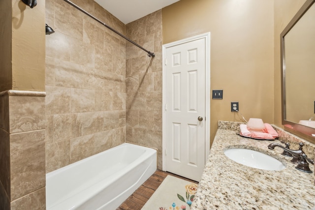 bathroom featuring tub / shower combination, wood finished floors, and vanity