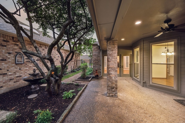 view of yard with ceiling fan and fence