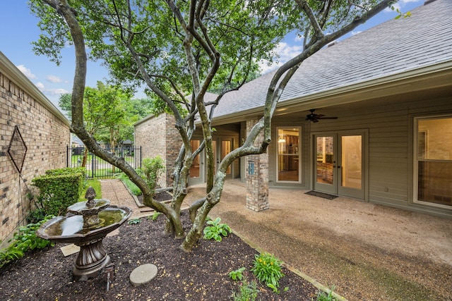 view of yard featuring fence, a ceiling fan, and a patio area