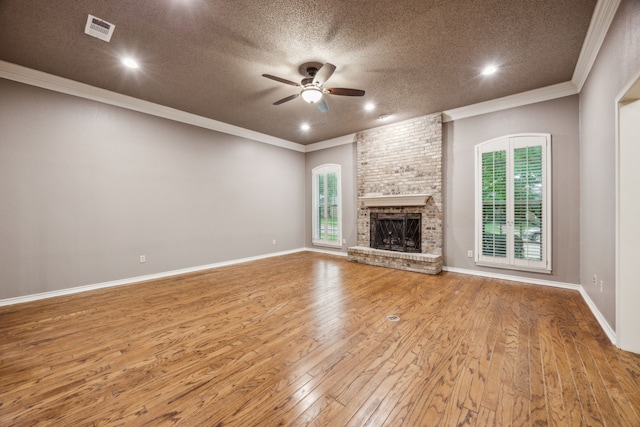 unfurnished living room with visible vents, a ceiling fan, a textured ceiling, and ornamental molding