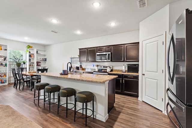 1823 Wolf Run, Anna, TX 75409 - kitchen featuring appliances with stainless steel finishes, a breakfast bar, a sink, and visible vents