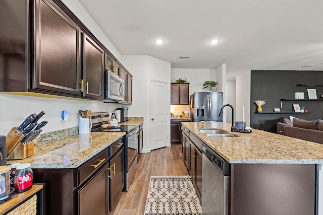 1823 Wolf Run, Anna, TX 75409 - kitchen featuring visible vents, dark brown cabinets, light wood-style floors, a sink, and appliances with stainless steel finishes